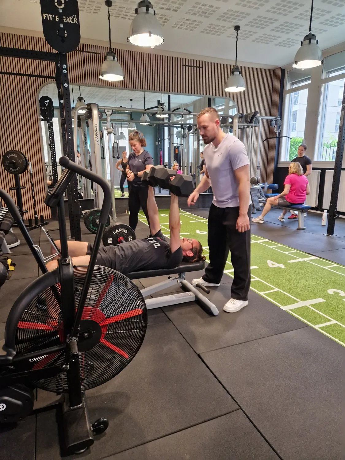 Développé couché aux haltères avec un coach, au studio Top Strength à Lyon 6